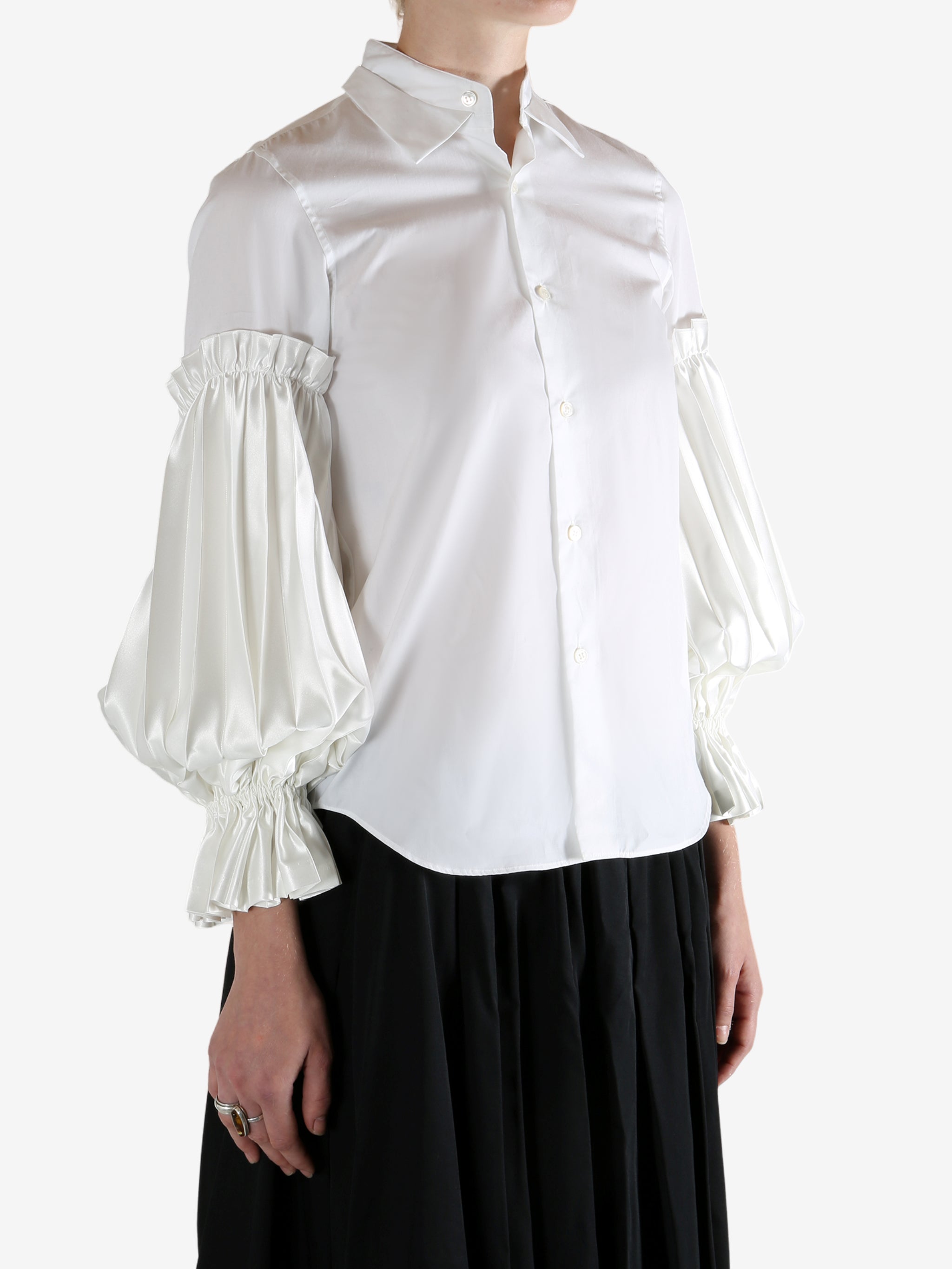 White shirt worn by a person, showing the shirt's fit