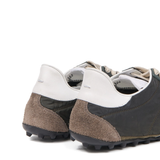 Close up of green sneakers, showing texture of the Polyester fabric