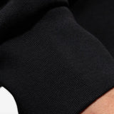 Close up of the black sweatshirt, showing texture of the cotton fabric