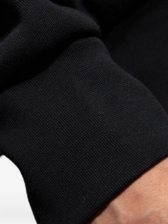 Close up of the black sweatshirt, showing texture of the cotton fabric