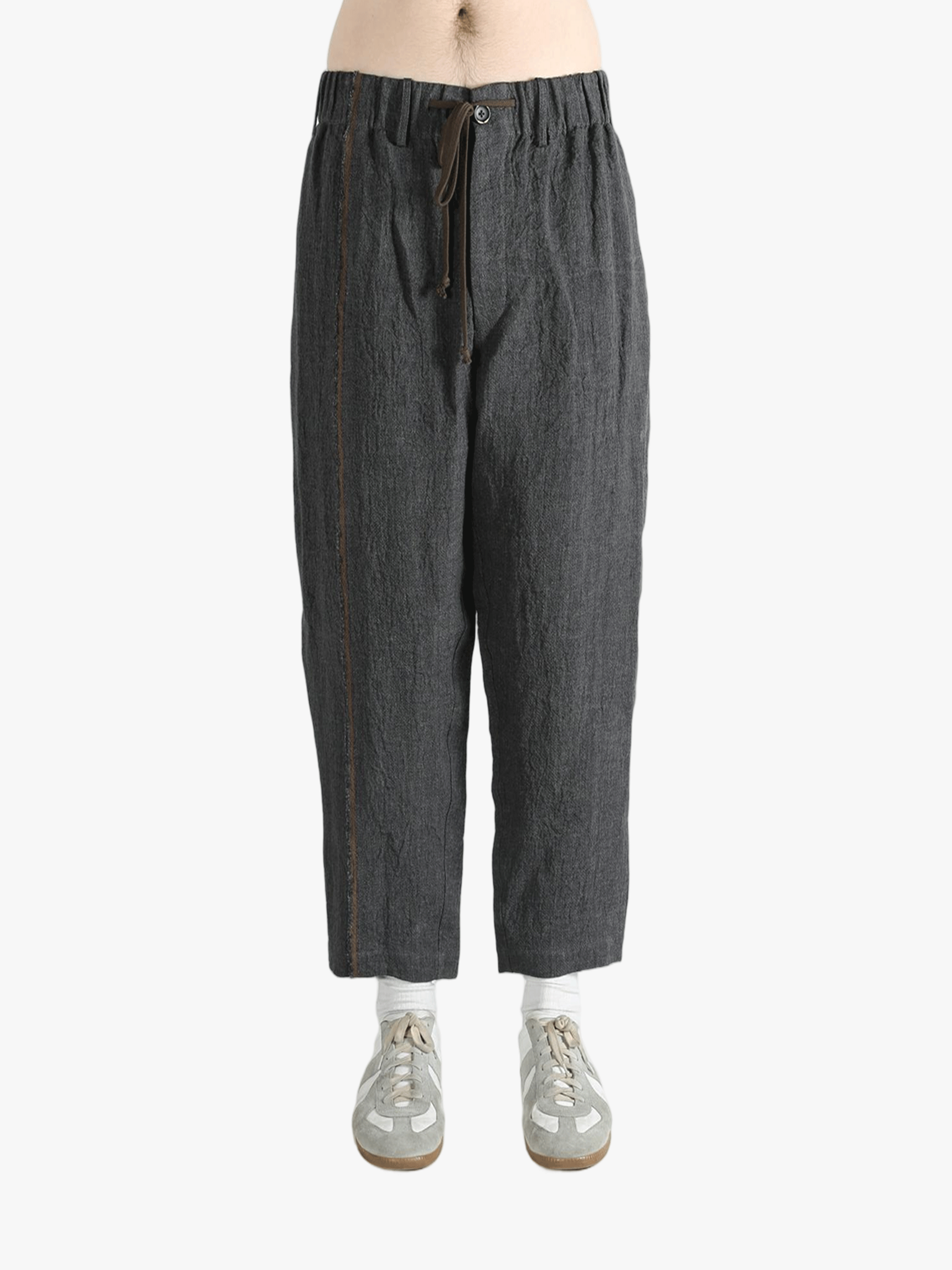 Grey pants worn by a person, showing the pants' fit