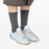 Blue shoes worn by a person, showing the shoes fit