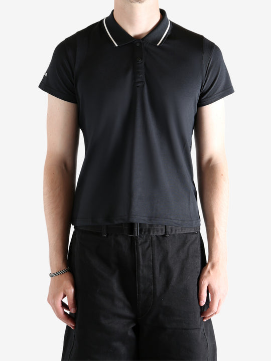 black shirts worn by a person, showing the shirts fit