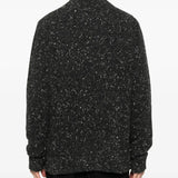 Black sweater worn by a person, showing the sweater fit