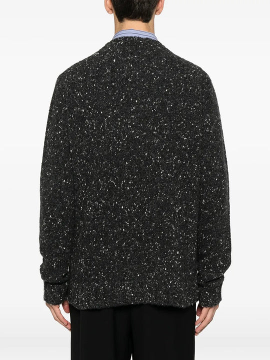 Black sweater worn by a person, showing the sweater fit