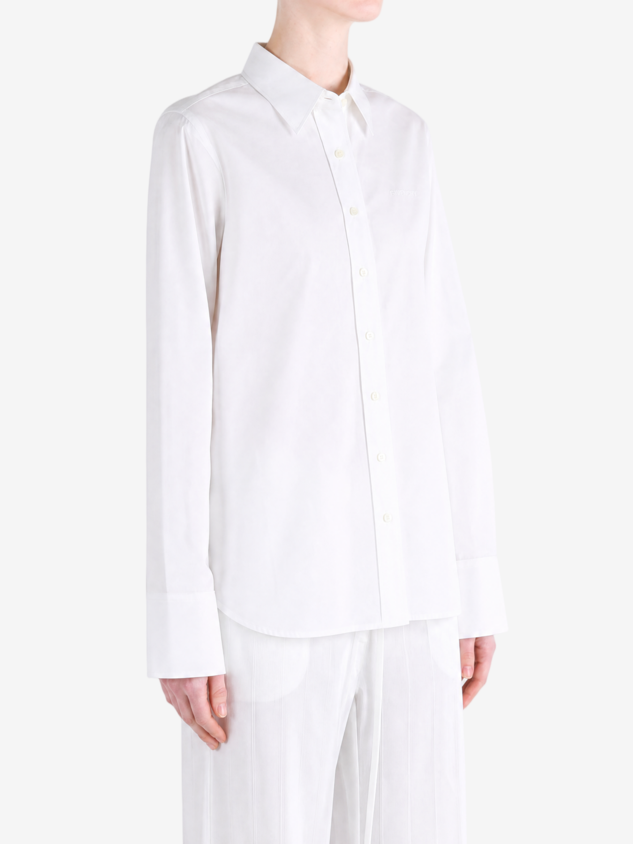 White shirt worn by a person, showing the shirt fit