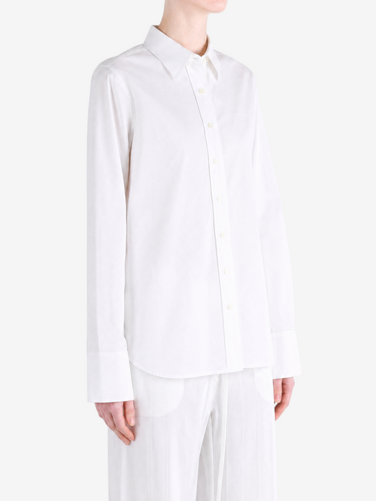 White shirt worn by a person, showing the shirt fit