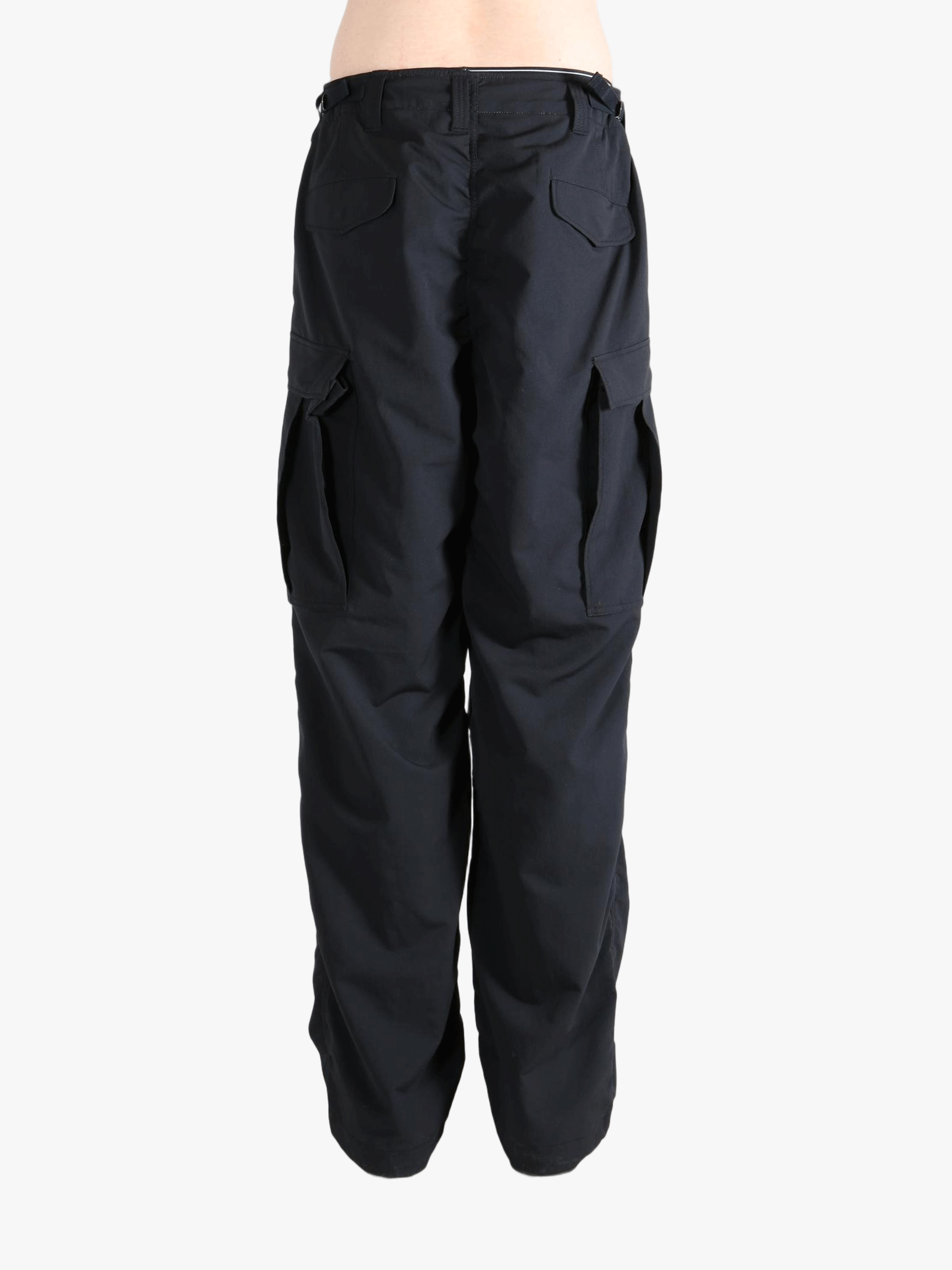 Black pants worn by a person, showing the pants fit