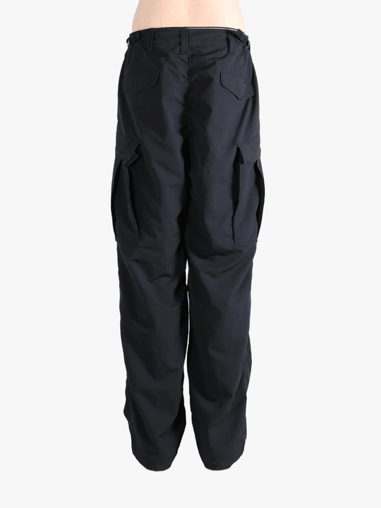 Black pants worn by a person, showing the pants fit
