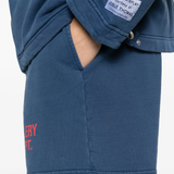 Close up of blue shorts, showing texture of the cotton fabric