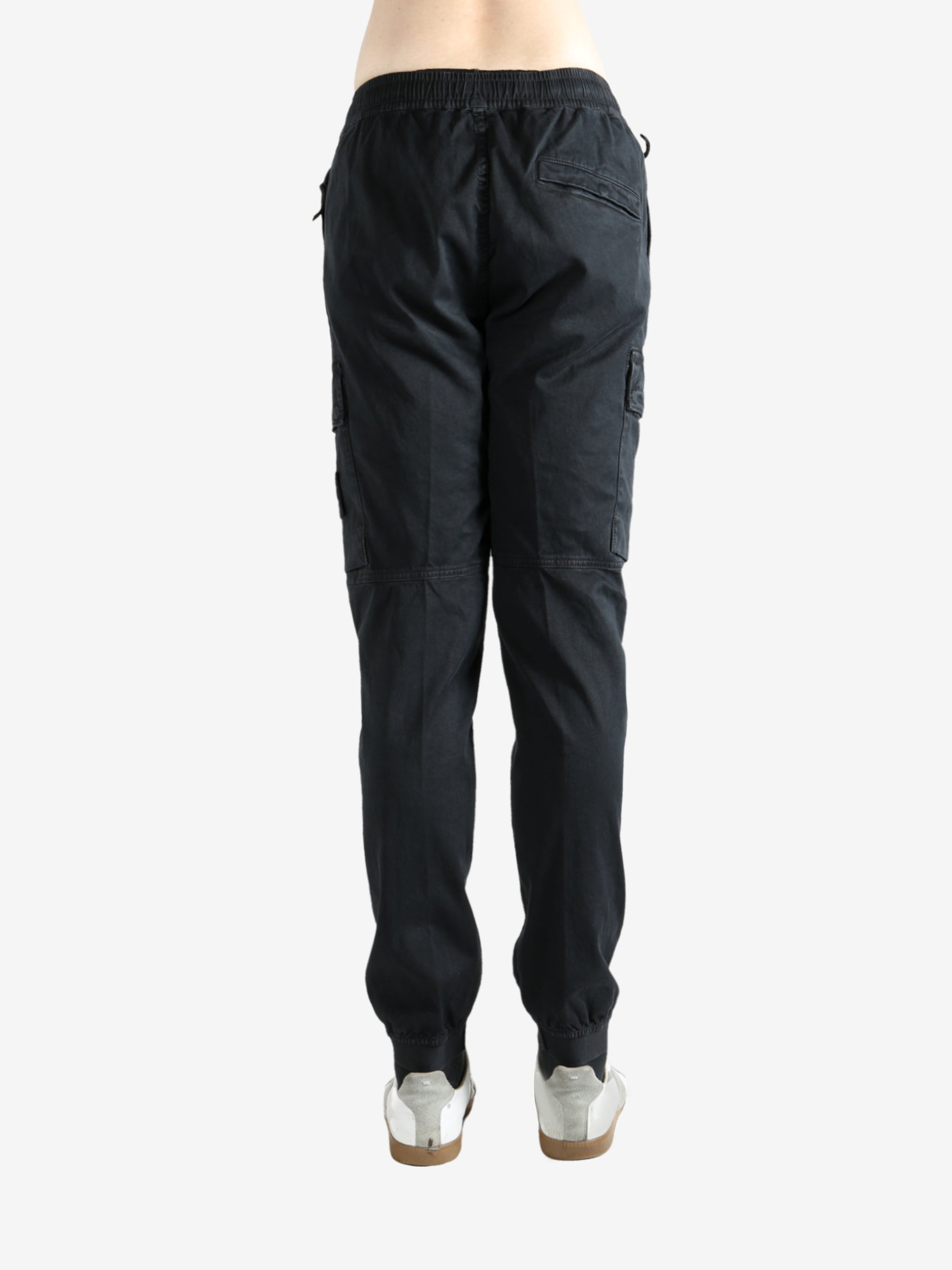 Black pants worn by a person, showing the pants' ft