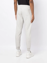 Grey pants worn by a person, showing the pants' fit