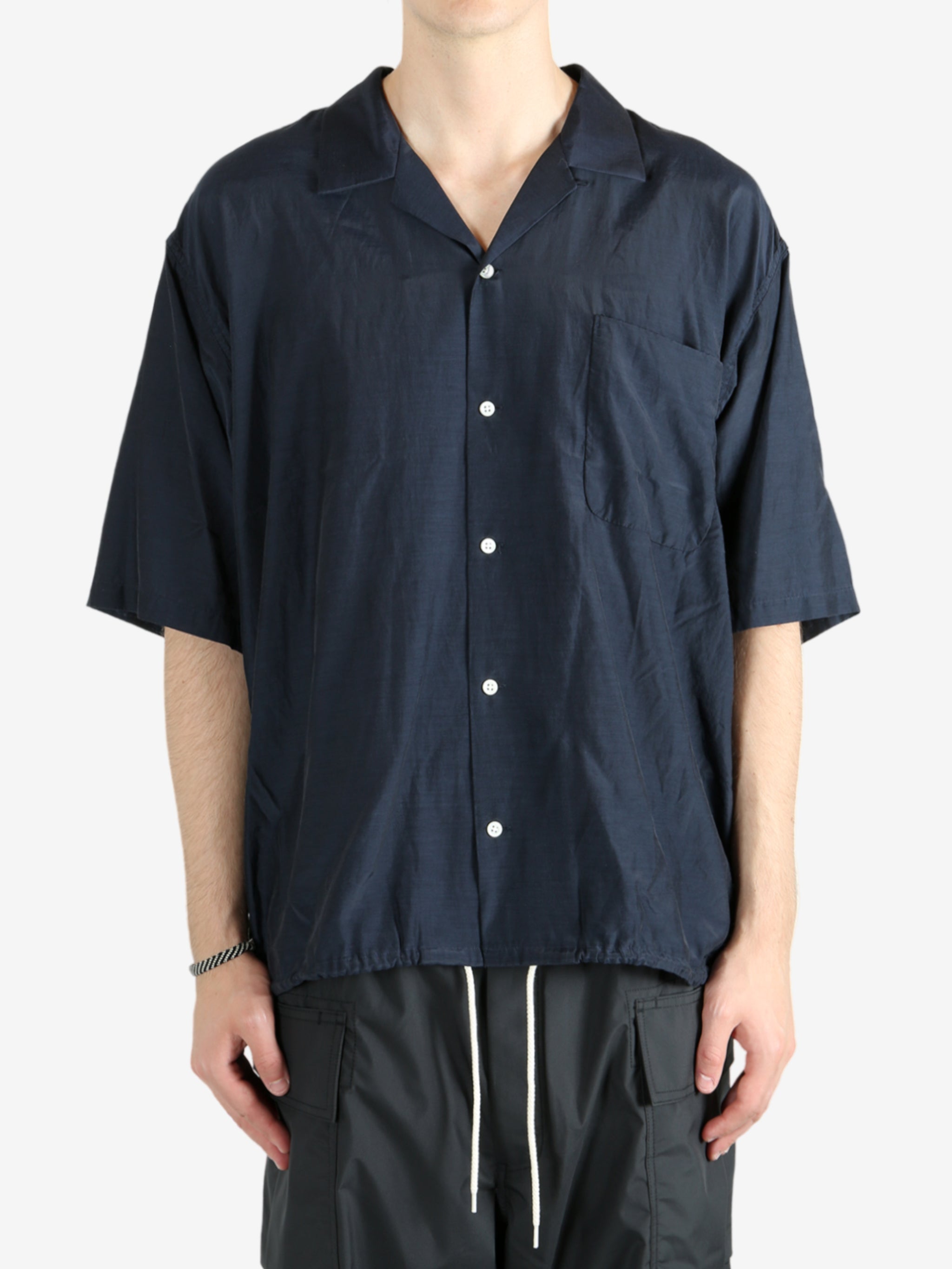 Blue shirt worn by a person, showing the shirt's fit