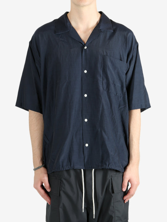 Blue shirt worn by a person, showing the shirt's fit