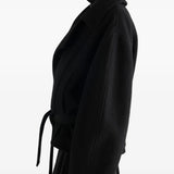 Black jacket worn by a person, showing the jacket fit