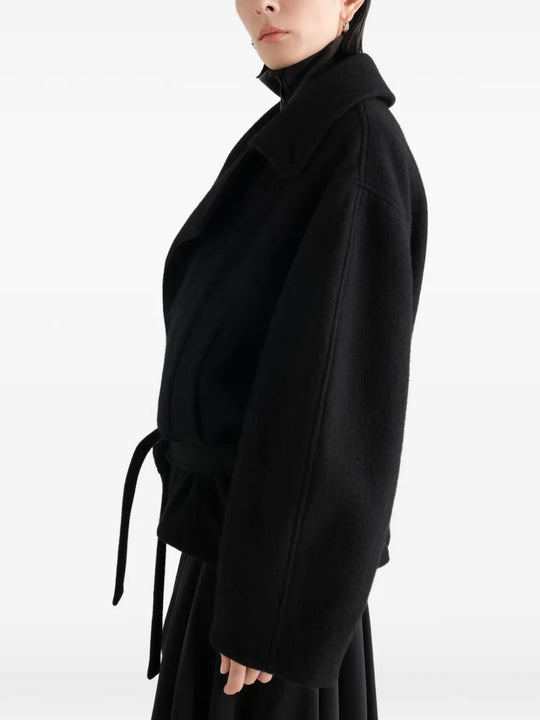 Black jacket worn by a person, showing the jacket fit