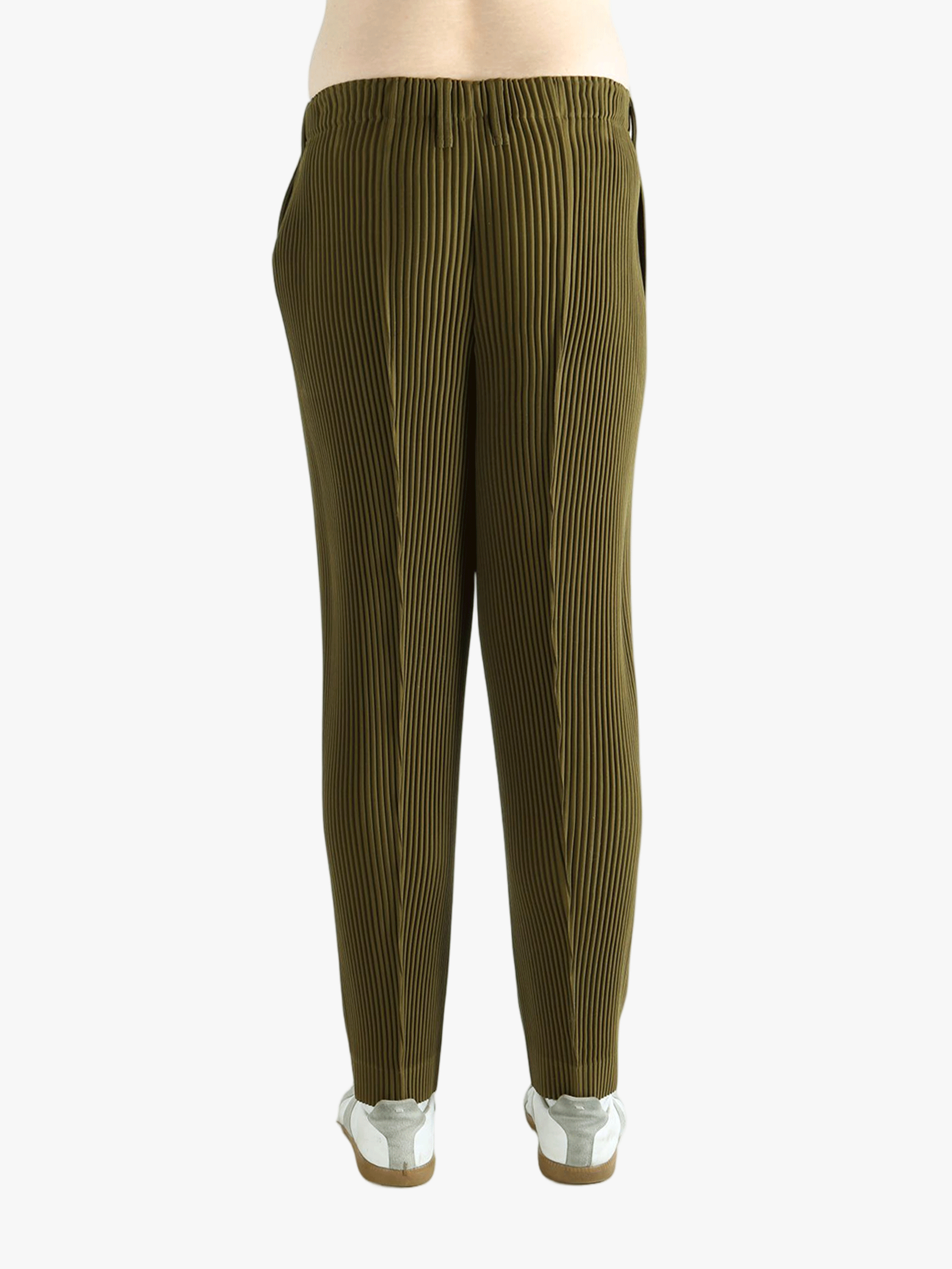 Green pants worn by a person, showing the pants' fit