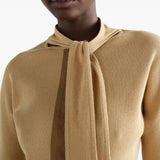 Tan shirt worn by a person, showing the shirt fit