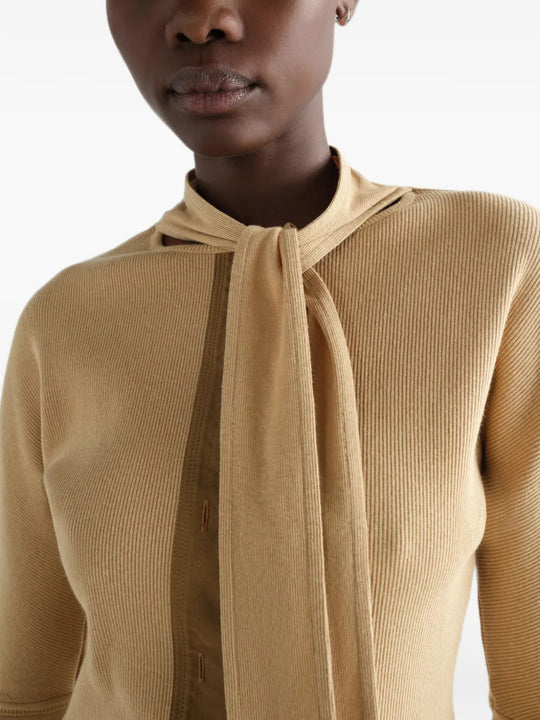 Tan shirt worn by a person, showing the shirt fit