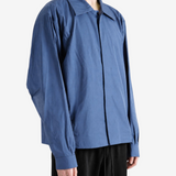 Blue jacket worn by a person, showing the jacket fit