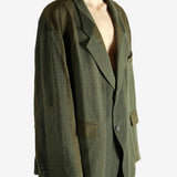 Green blazer worn by a person, showing the blazer's fit