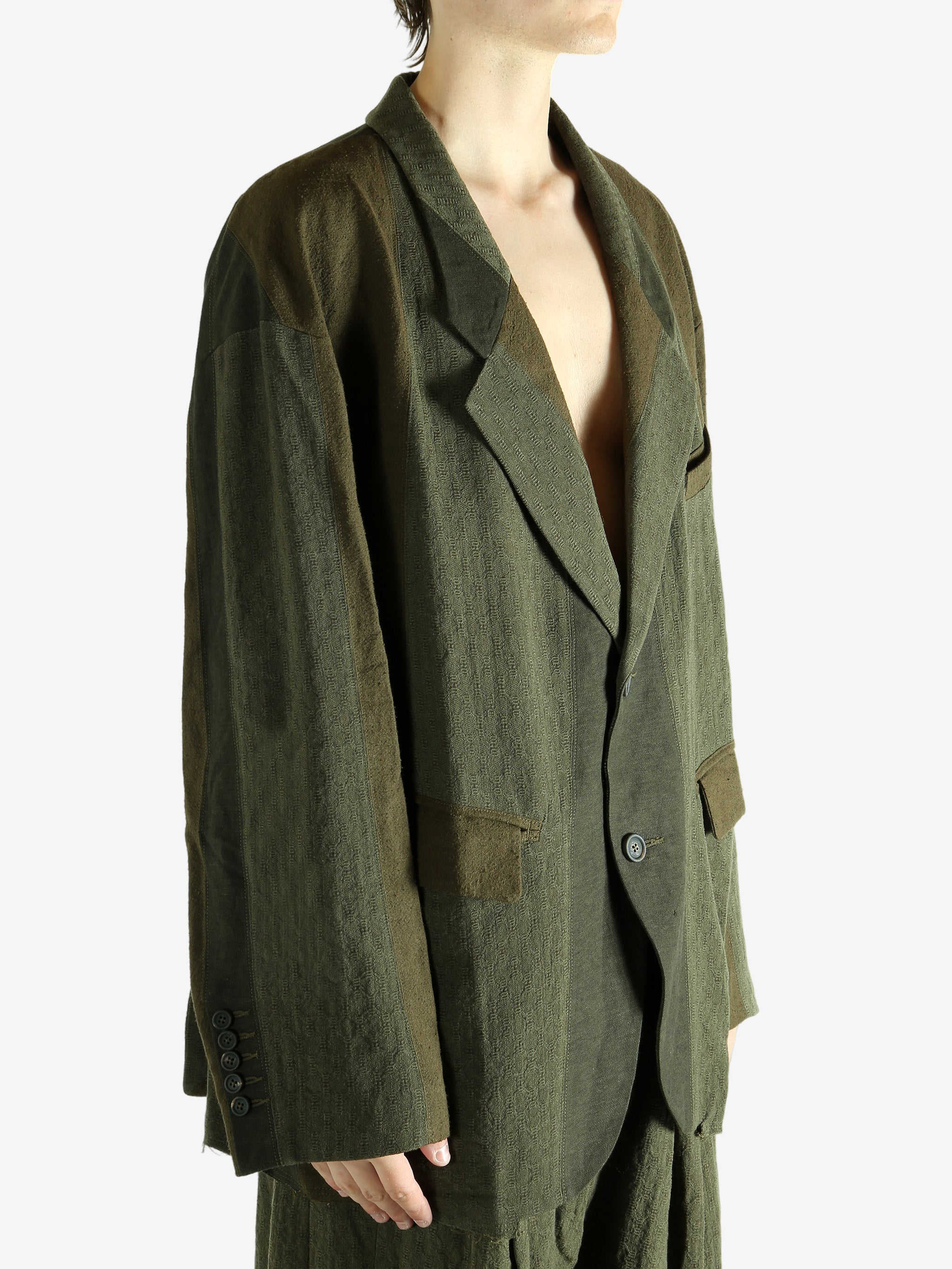 Green blazer worn by a person, showing the blazer's fit