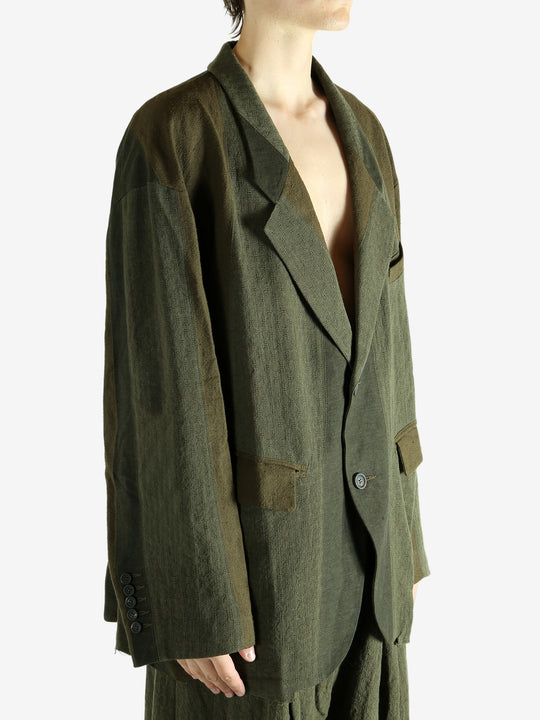 Green blazer worn by a person, showing the blazer's fit