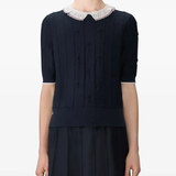 Navy top worn by a person, showing the top fit