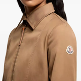 Close up of brown jackets-coats, showing texture of the polyester fabric