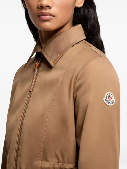 Close up of brown jackets-coats, showing texture of the polyester fabric