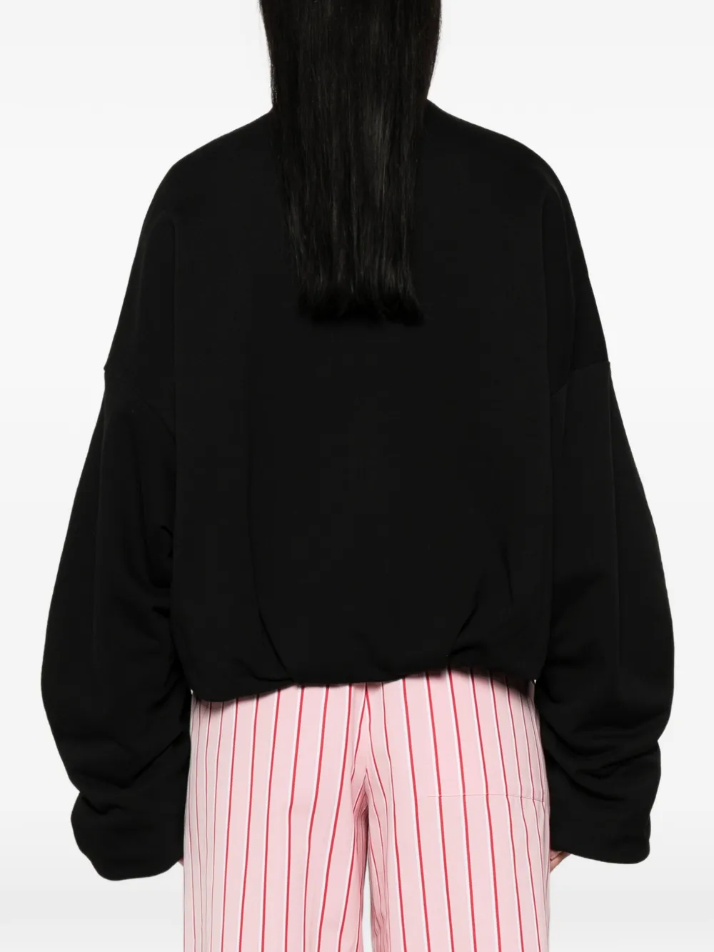 Black jacket worn by a person, showing the jacket's fit