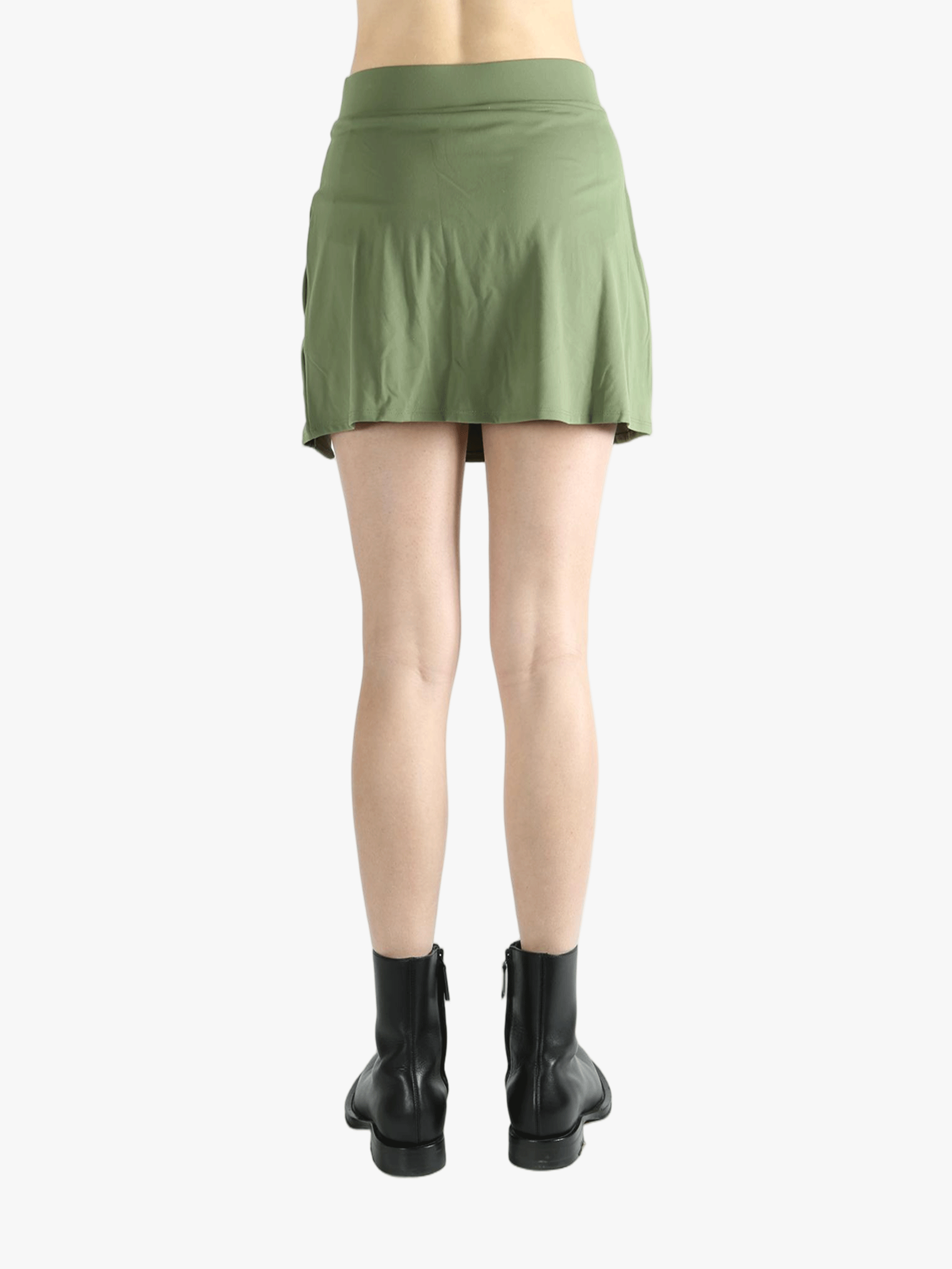 Green skirt worn by a person, showing the loose fit.