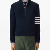 navy knitwear worn by a person, showing the knitwear fit