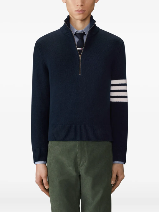 navy knitwear worn by a person, showing the knitwear fit