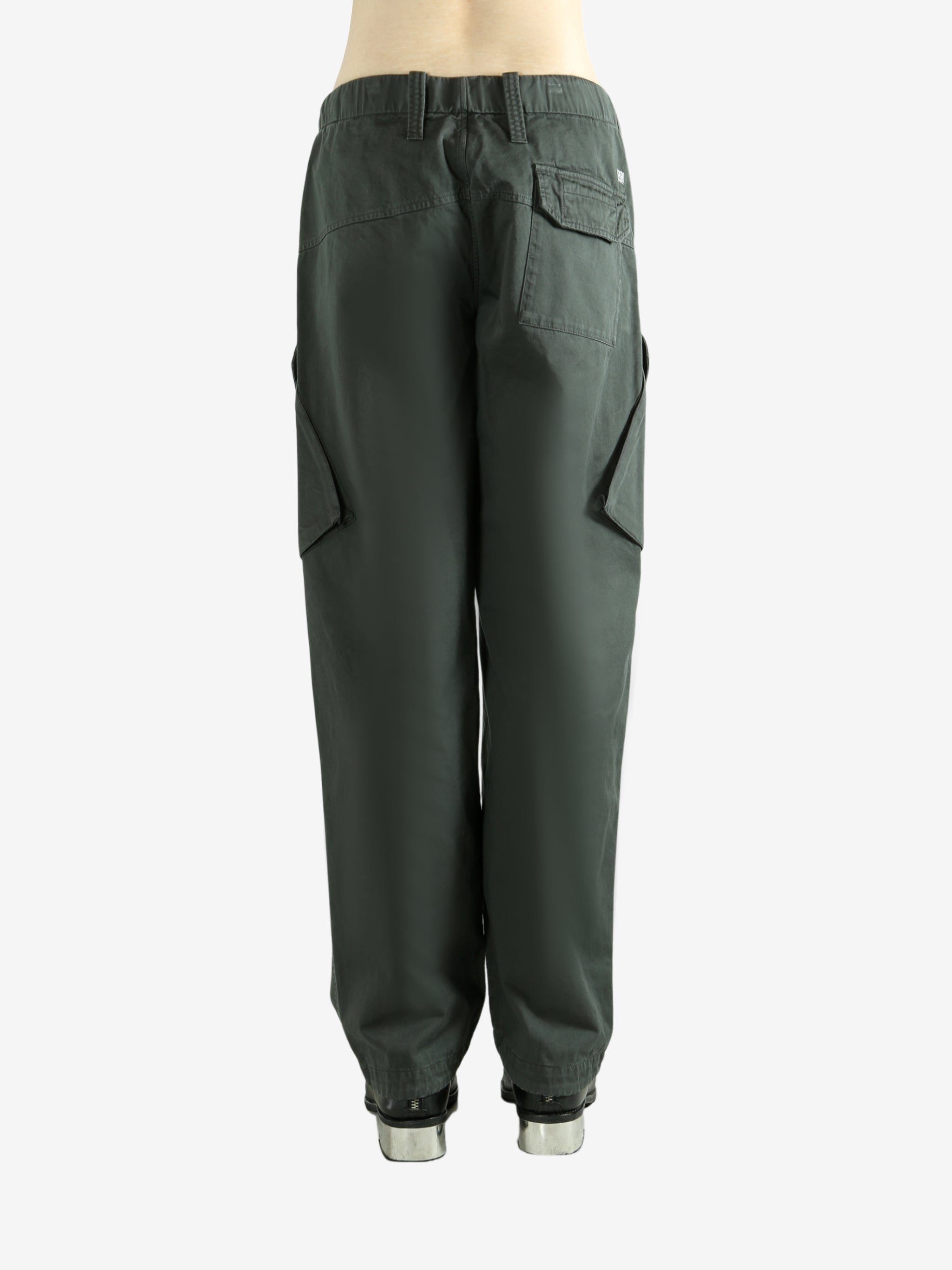 Green pants worn by a person, showing the pants fit