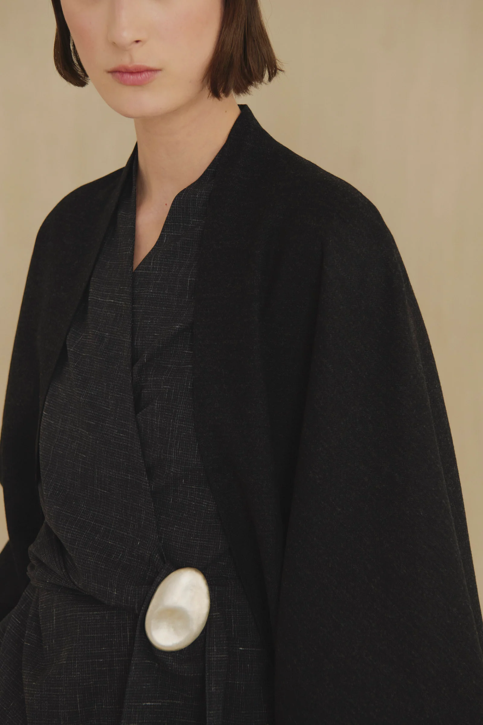 Black jacket worn by a person, showing the jacket fit