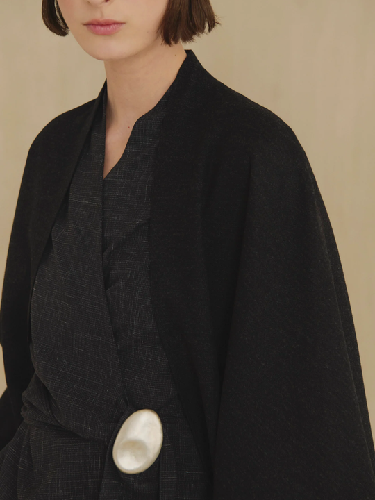 Black jacket worn by a person, showing the jacket fit