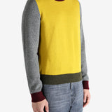 Grey knitwear worn by a person, showing the knitwear's fit