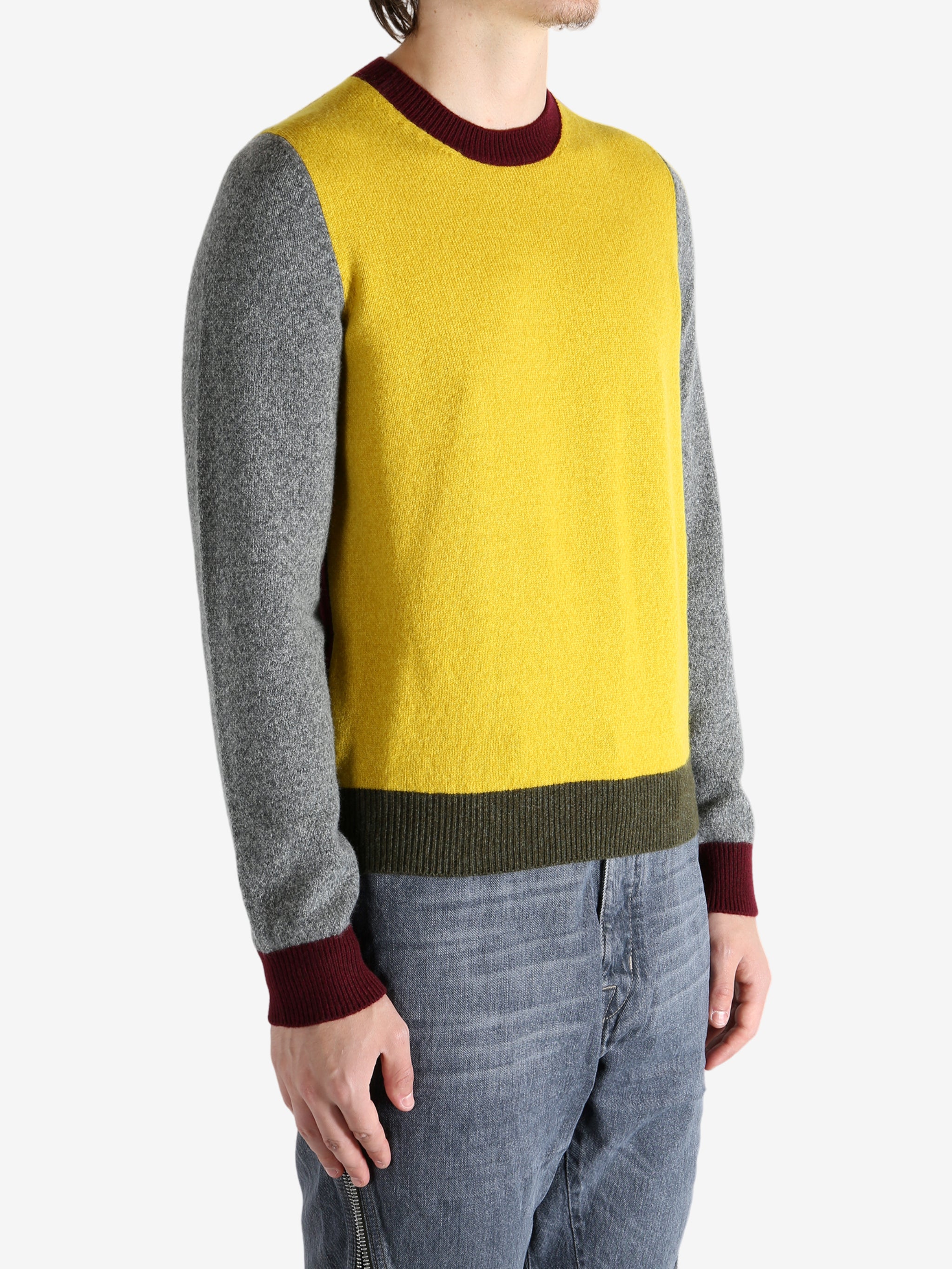 Grey knitwear worn by a person, showing the knitwear's fit