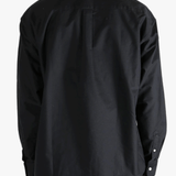 Black shirt worn by a person, showing the shirt's fit