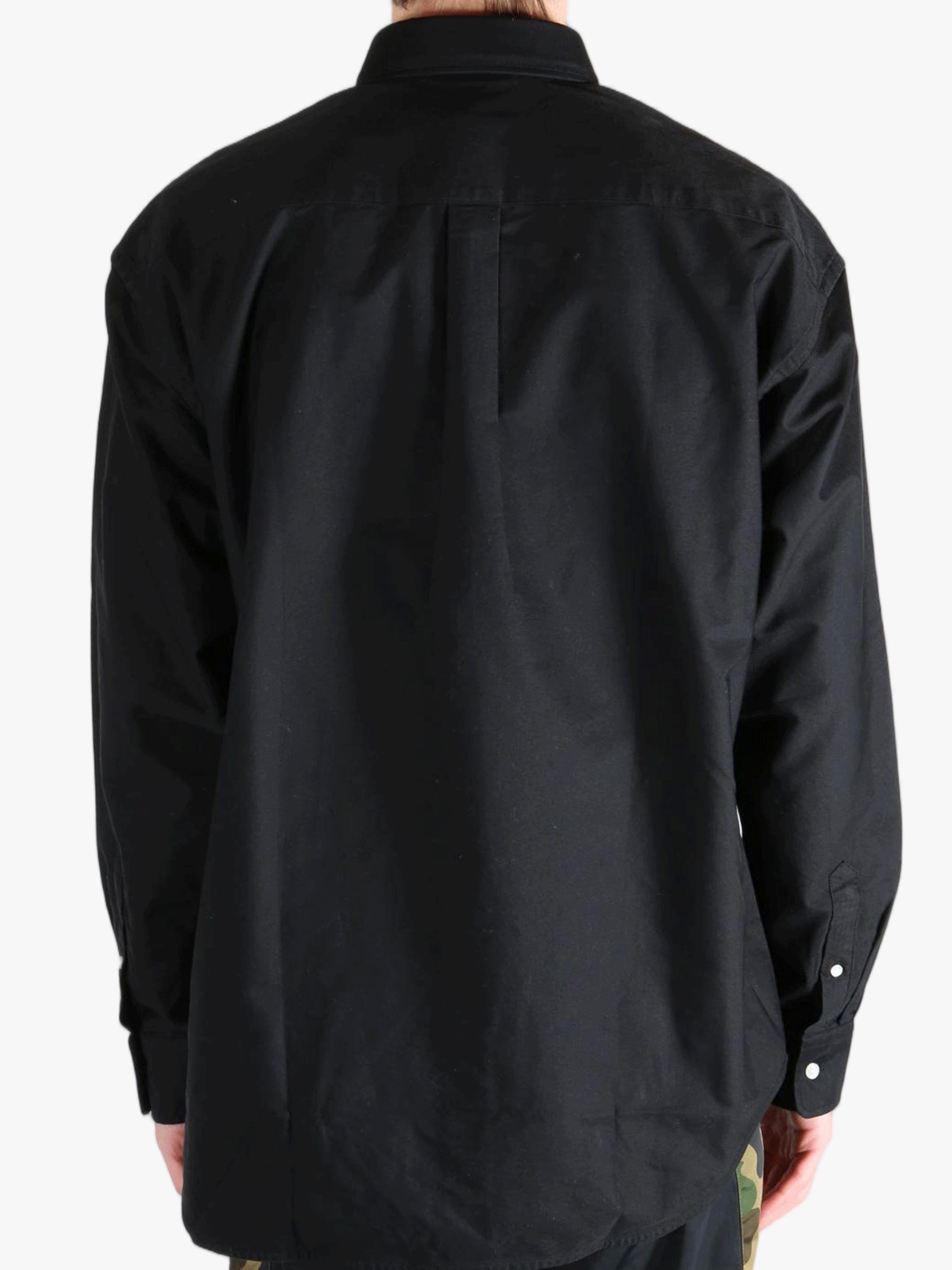 Black shirt worn by a person, showing the shirt's fit