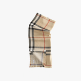 Close up of tan scarve, showing texture of the silk fabric