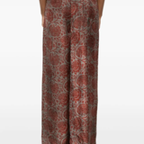 Red pants worn by a person, showing the pants fit