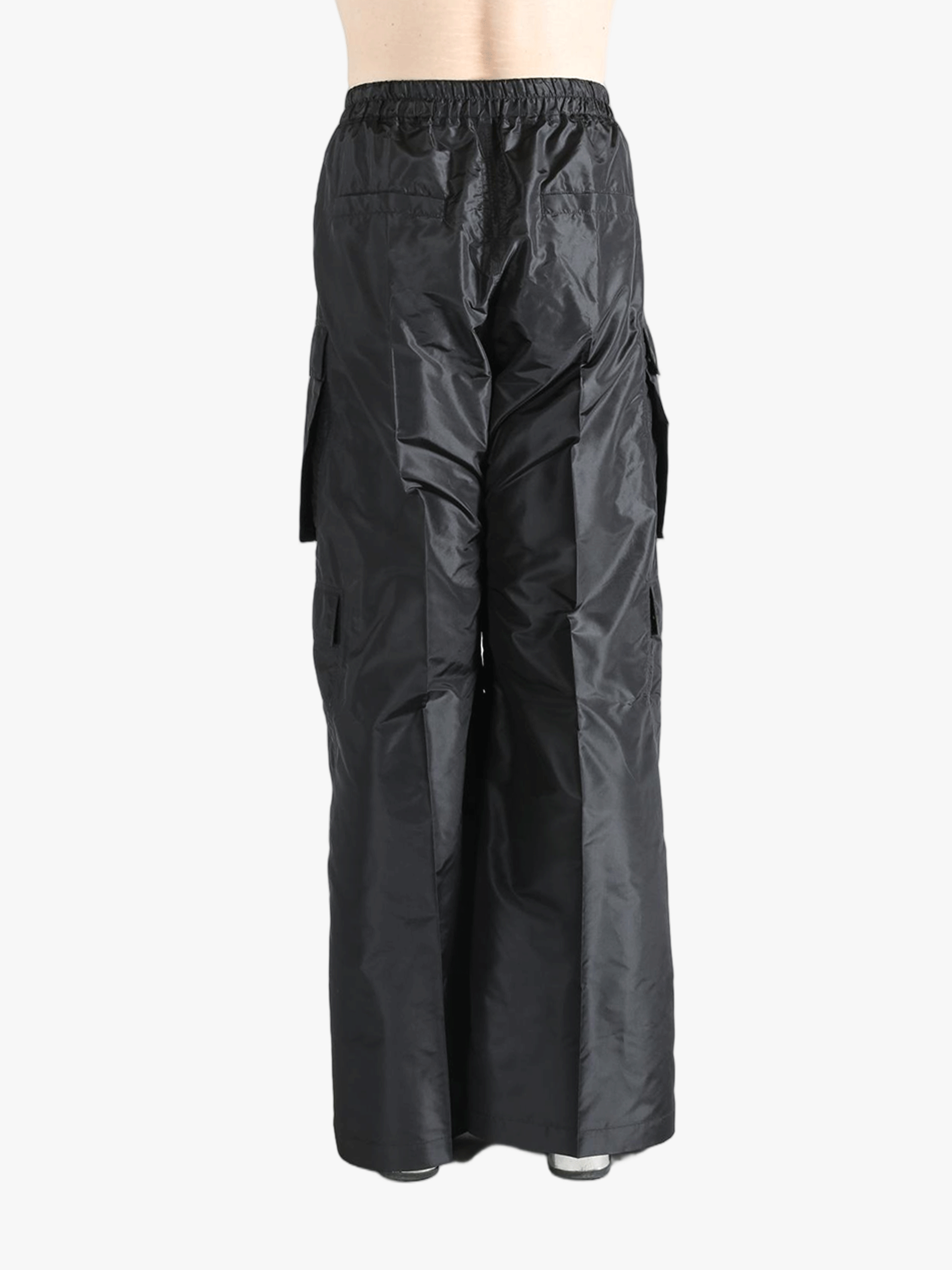 Black pants worn by a person, showing the pants's fit