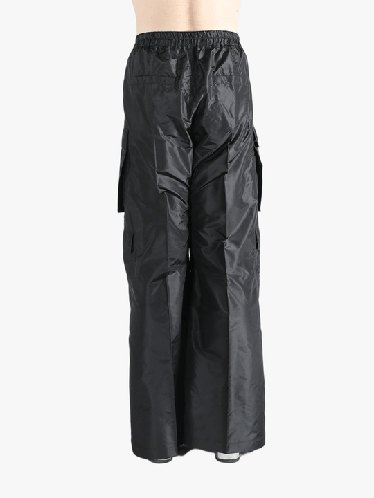 Black pants worn by a person, showing the pants's fit