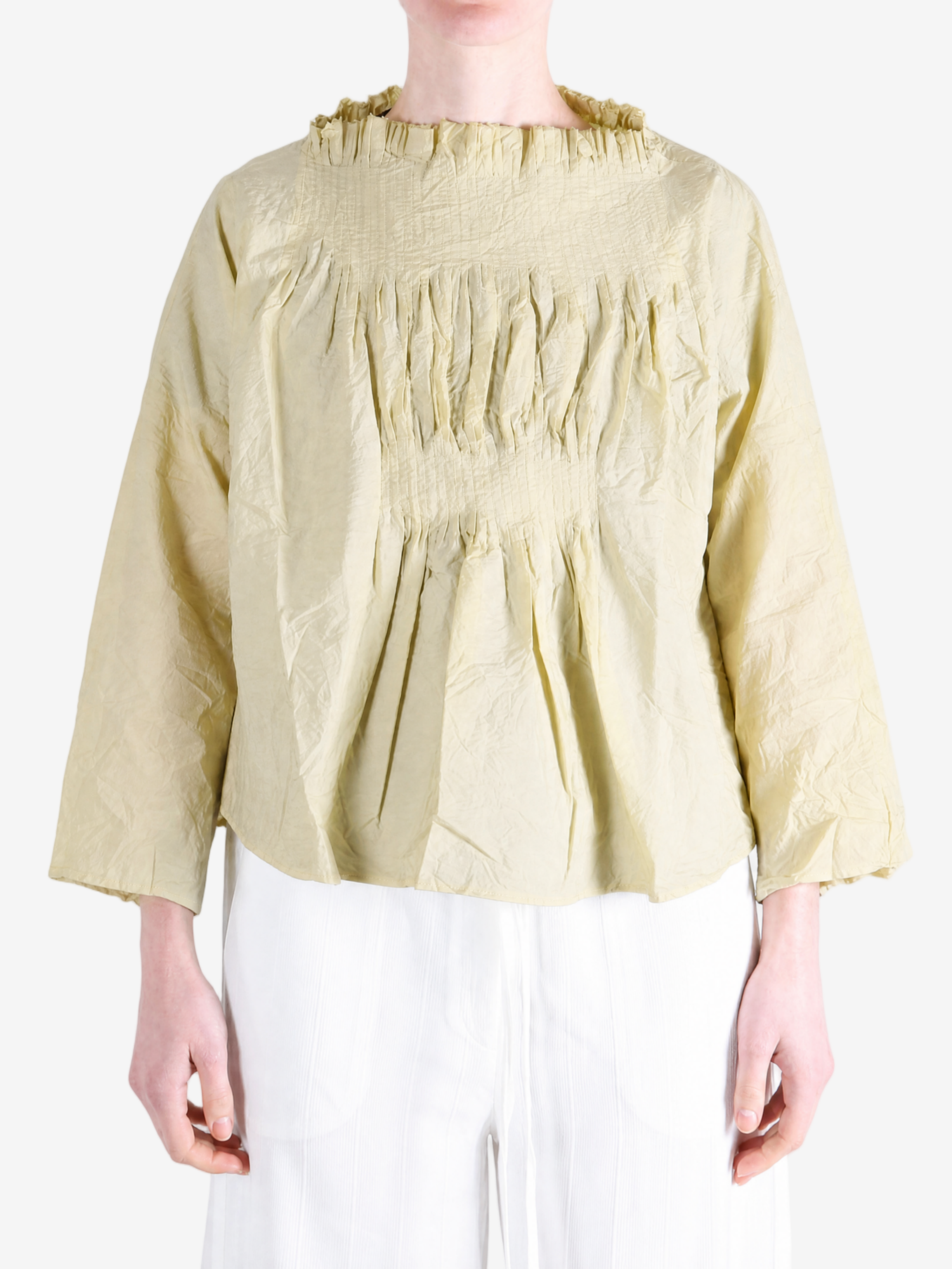Tan shirt worn by a person, showing the shirt fit