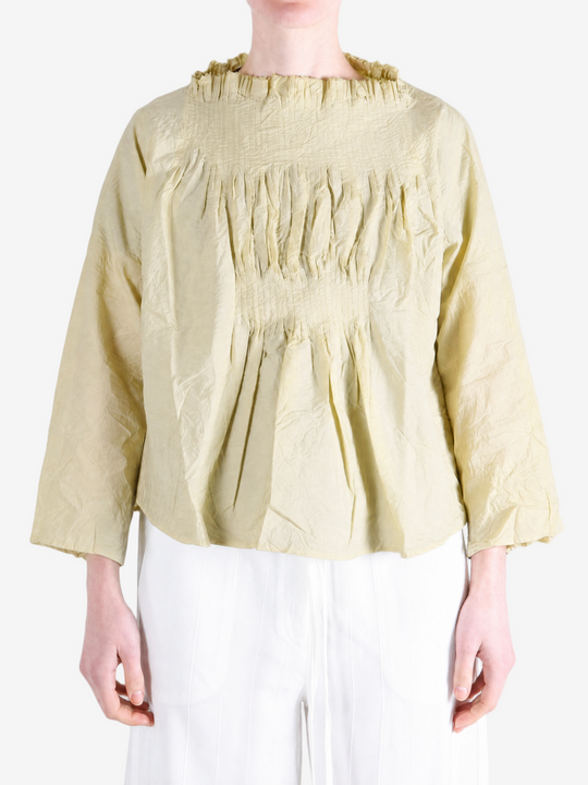 Tan shirt worn by a person, showing the shirt fit