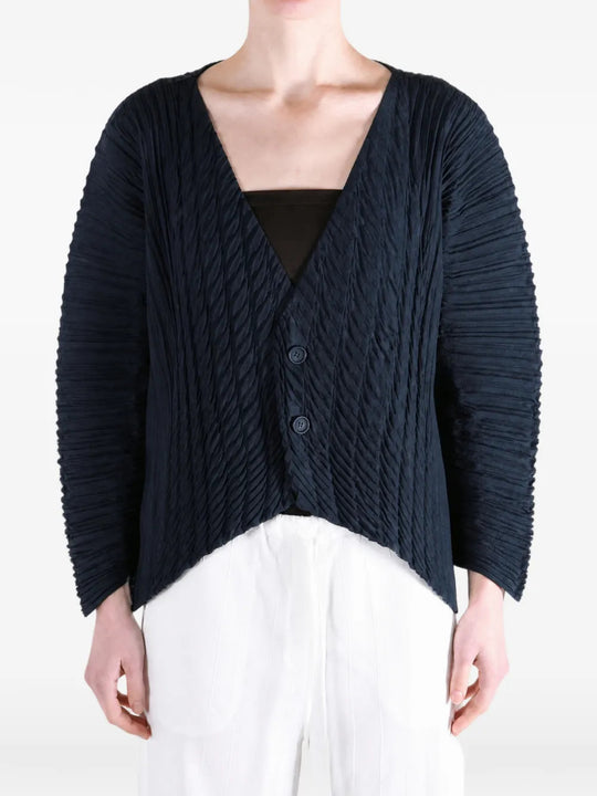 Navy knitwear worn by a person, showing the knitwear fit
