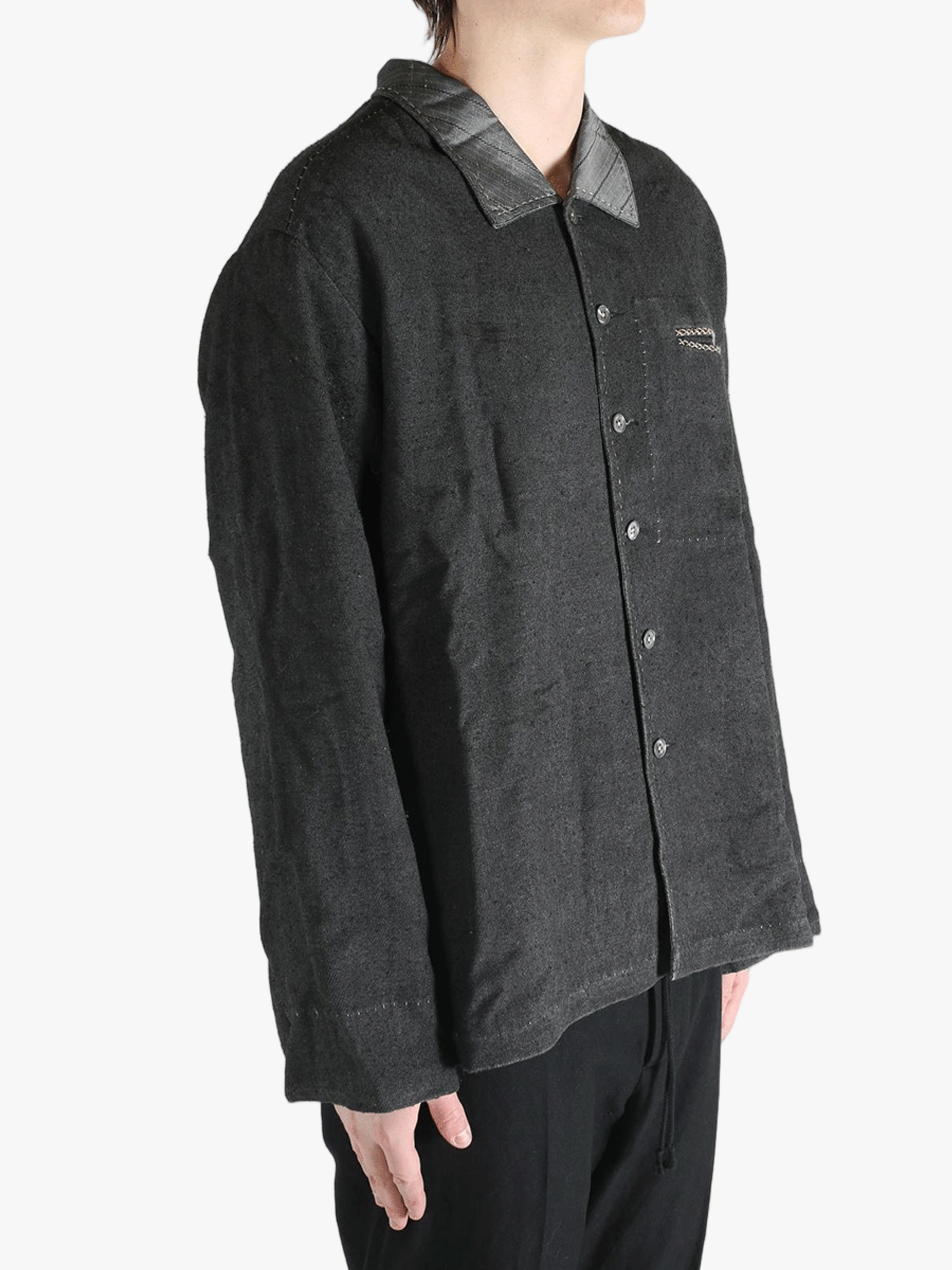 Grey shirts worn by a person, showing the shirts fit