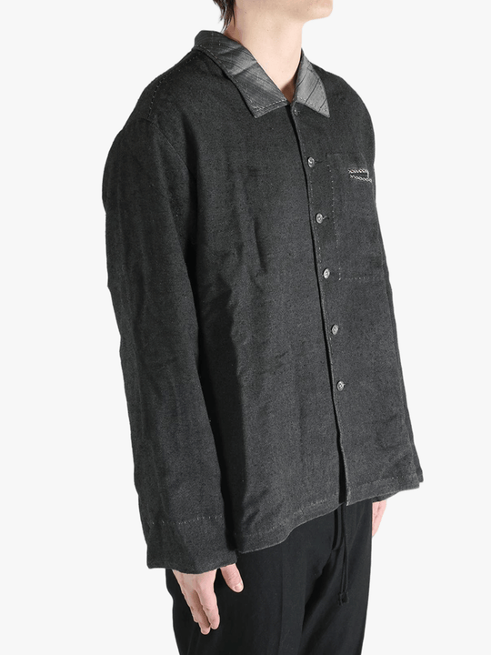 Grey shirts worn by a person, showing the shirts fit